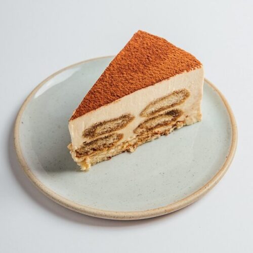 Tiramisu cake slice served on a plate