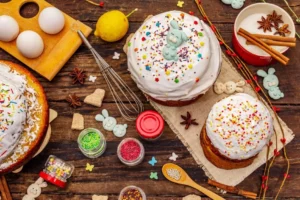 Easter cakes with white icing and bunny decorations on a wooden table