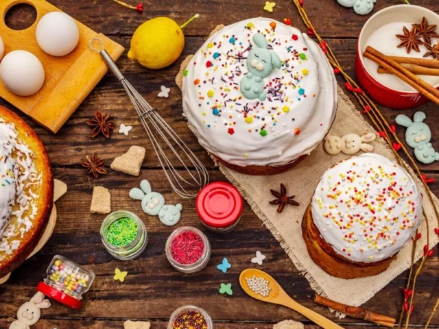 Easter cakes with white icing and bunny decorations on a wooden table
