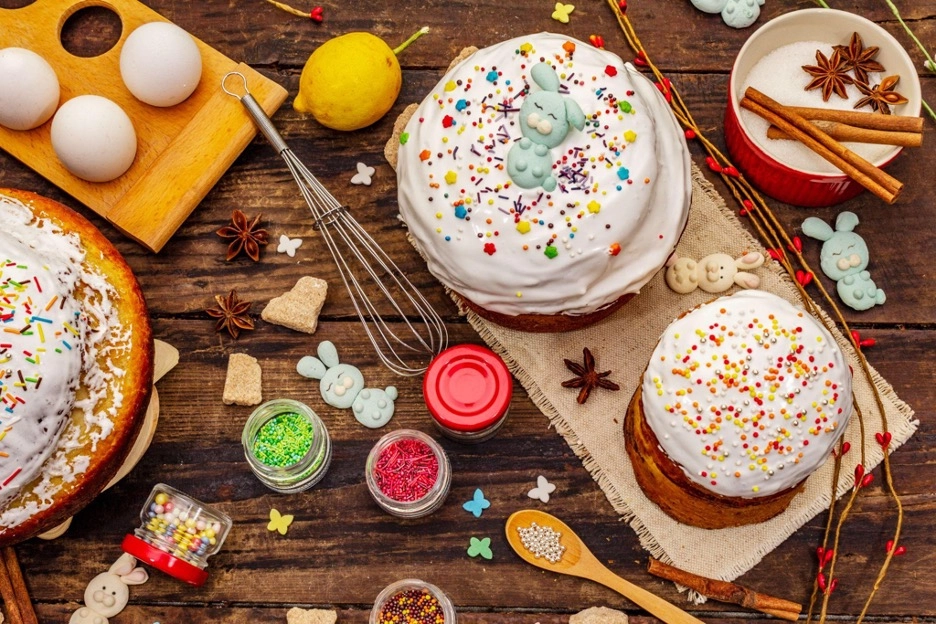 Easter cakes with white icing and bunny decorations on a wooden table