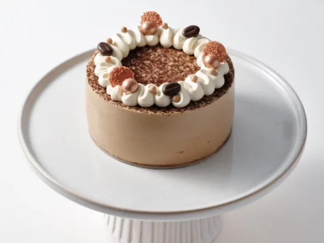 coffee rum and raisin cake with cream and cocoa